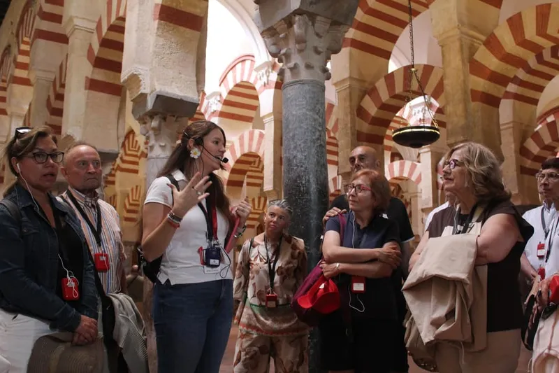 Red-and-white double horseshoe arches in the prayer hall on a mosque cathedral of cordoba tour in Córdoba, Spain
