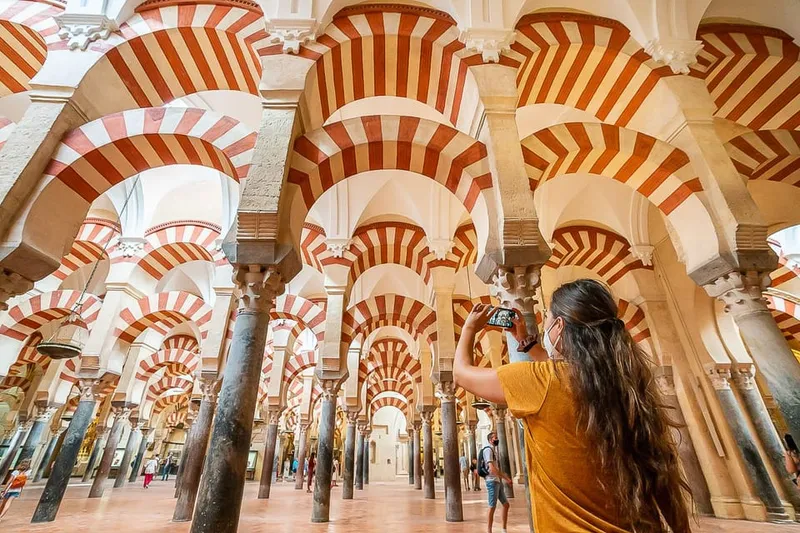 Official guide leading visitors past the mihrab on a mosque cathedral of cordoba tour in Córdoba, Spain