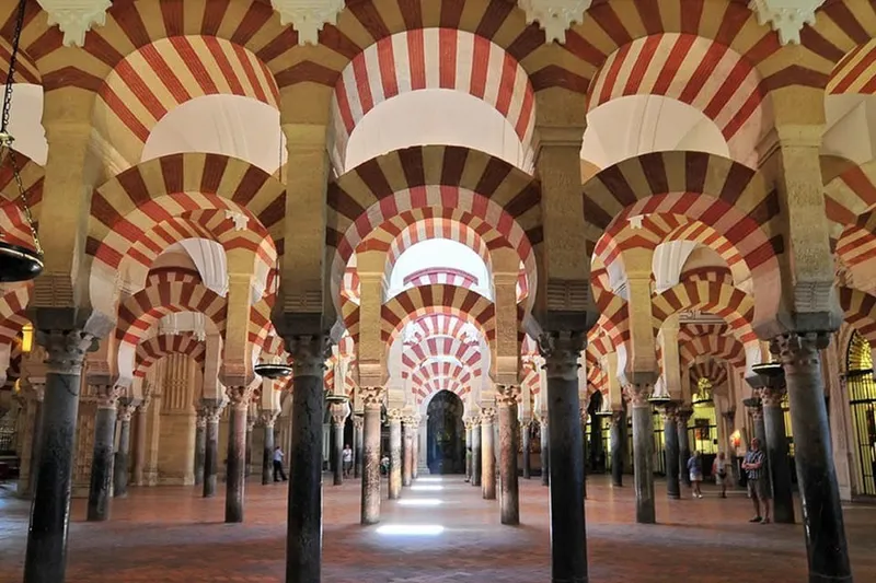 The Mosque-Cathedral bell tower seen from the Roman Bridge on a mosque cathedral of cordoba day tour from Seville, Spain